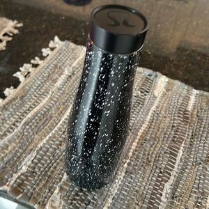 Lululemon water bottle. Black with white speckles.  Screw top black lid.